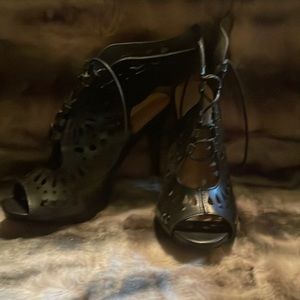 Black open toe cutout lace up booties with buckle detail.